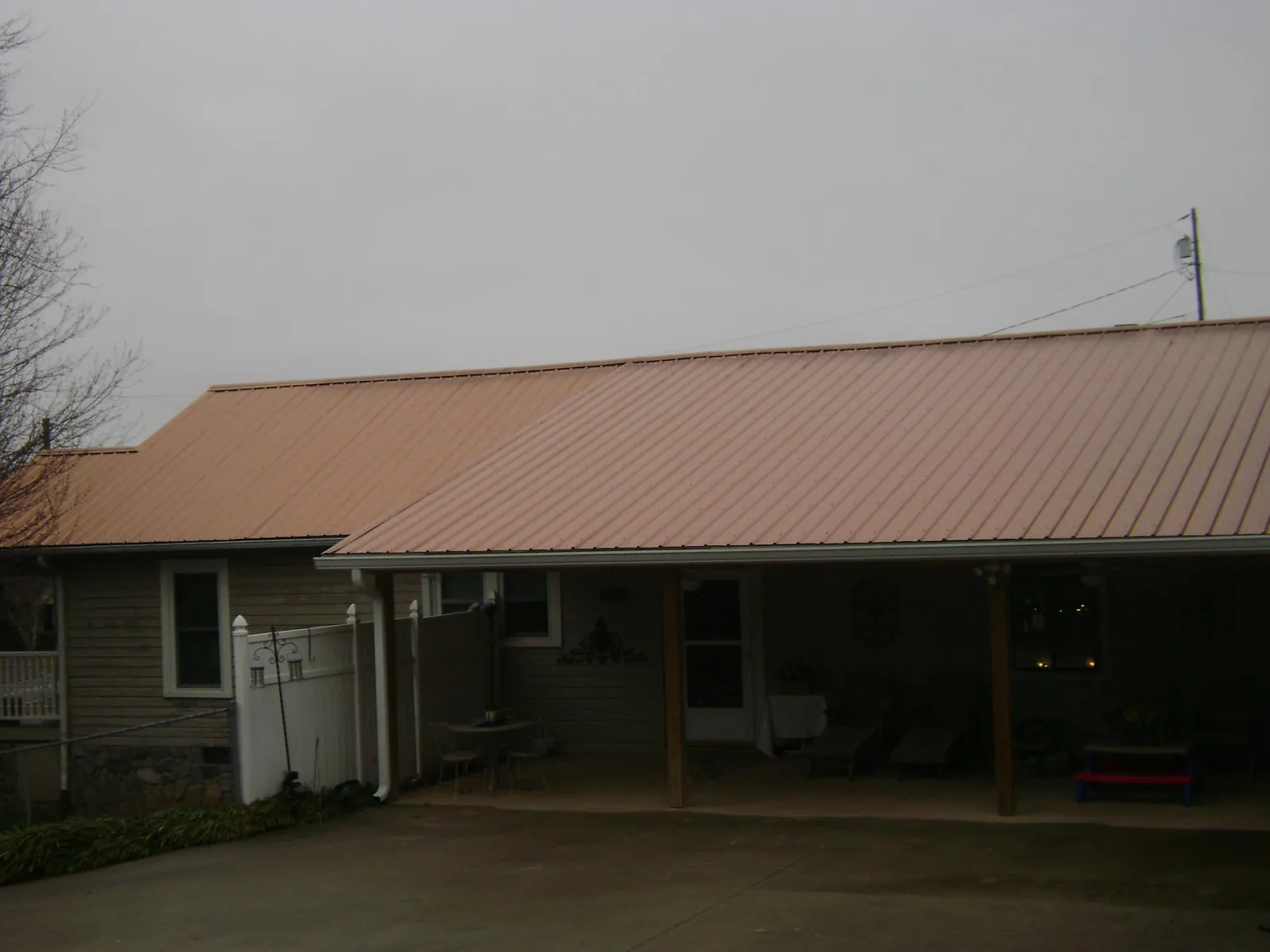 Copper toned metal roof over a wide covered patio in Brownsville